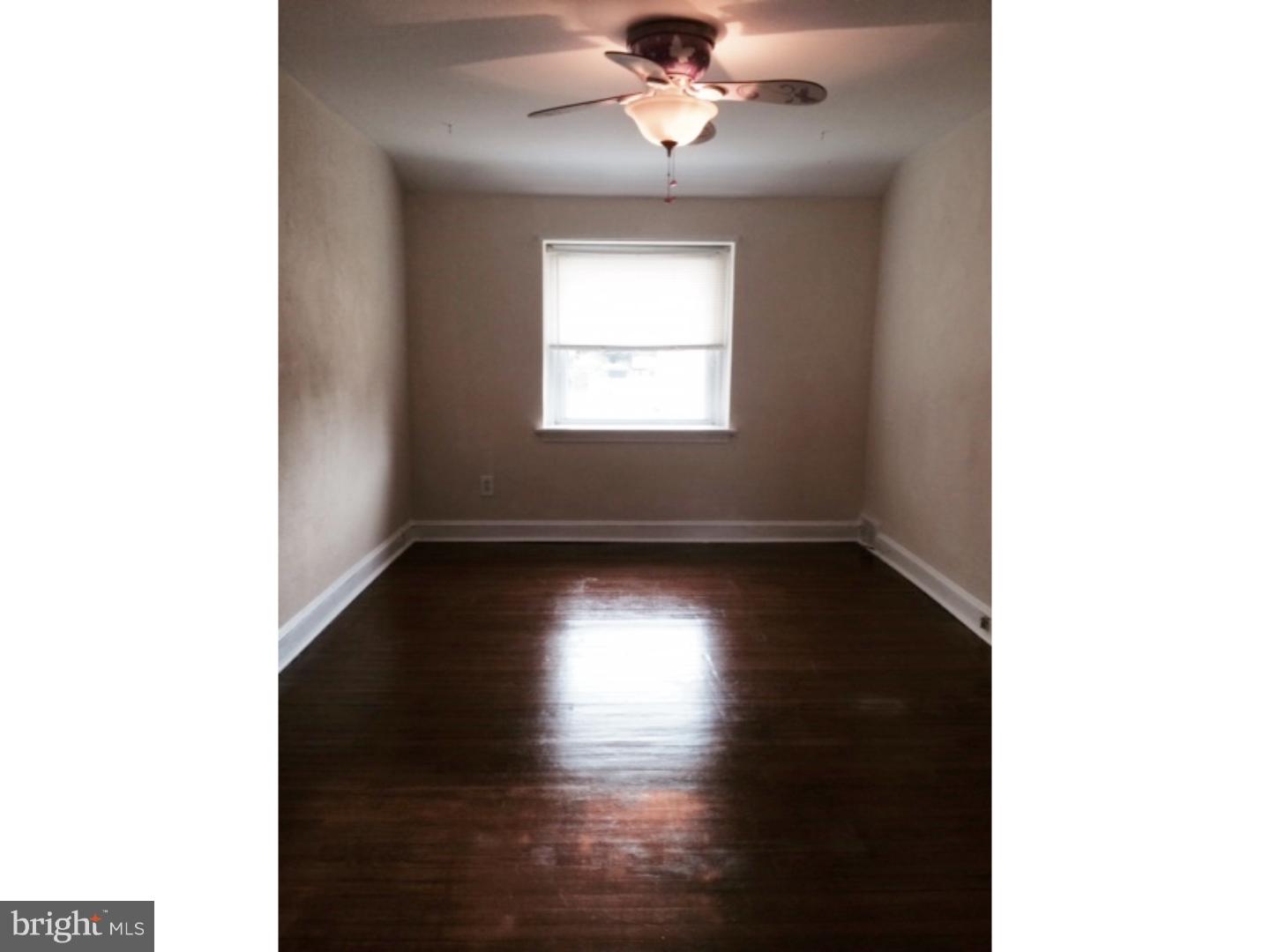 737 Hilltop Road Springfield, PA 19064 - Photo 16 of 24 a view of an empty room with wooden floor and a window