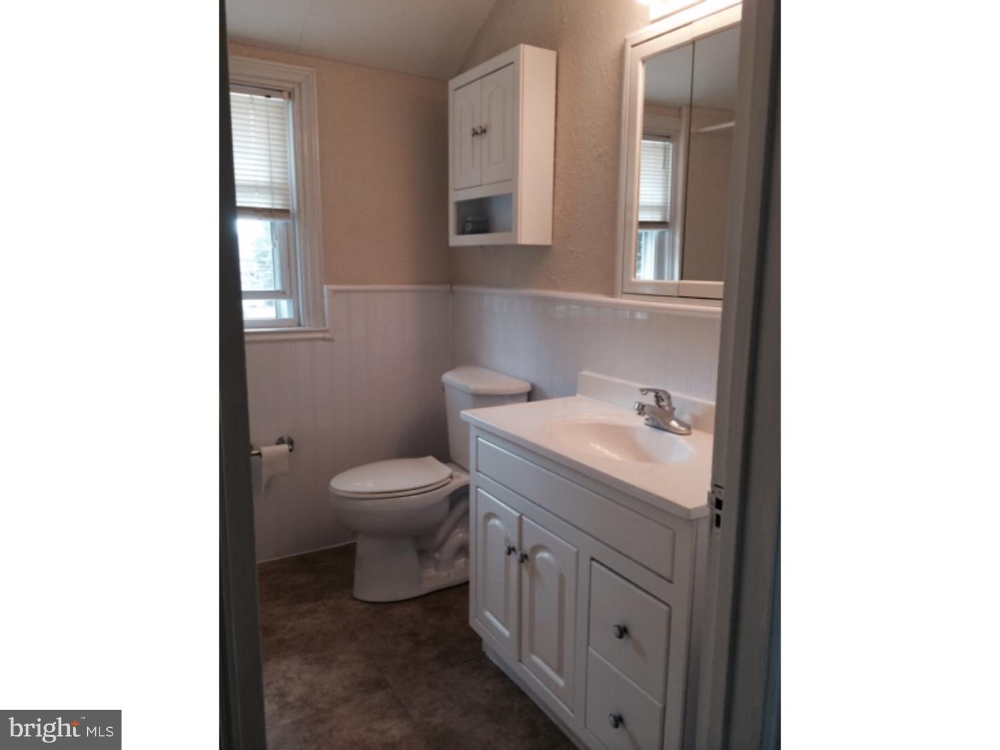 737 Hilltop Road Springfield, PA 19064 - Photo 18 of 24 a bathroom with a toilet a sink and mirror