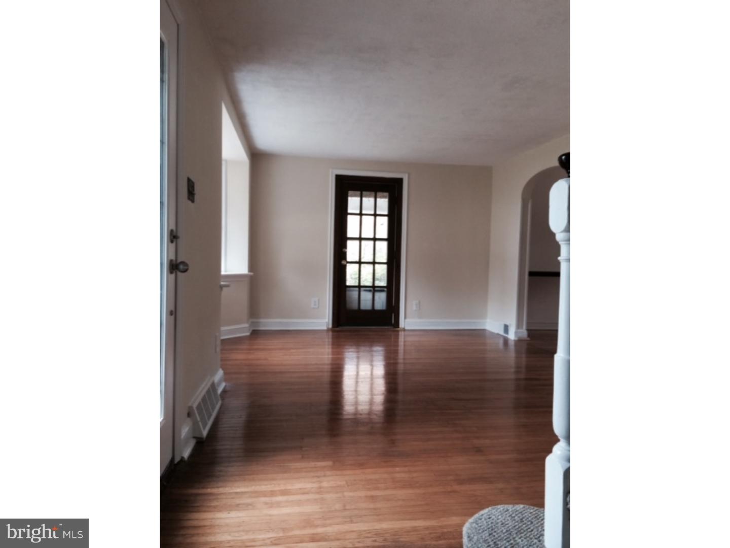 737 Hilltop Road Springfield, PA 19064 - Photo 4 of 24 a view of a hallway with wooden floor and staircase
