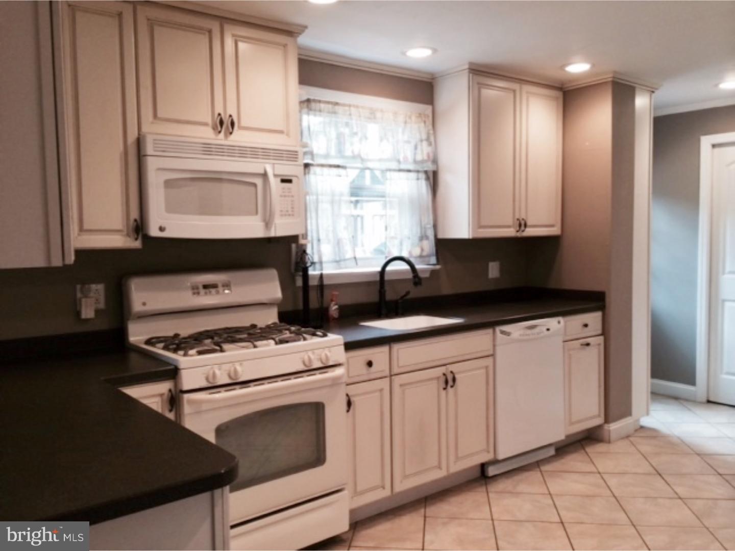 737 Hilltop Road Springfield, PA 19064 - Photo 8 of 24 a kitchen with stainless steel appliances granite countertop a sink stove and cabinets