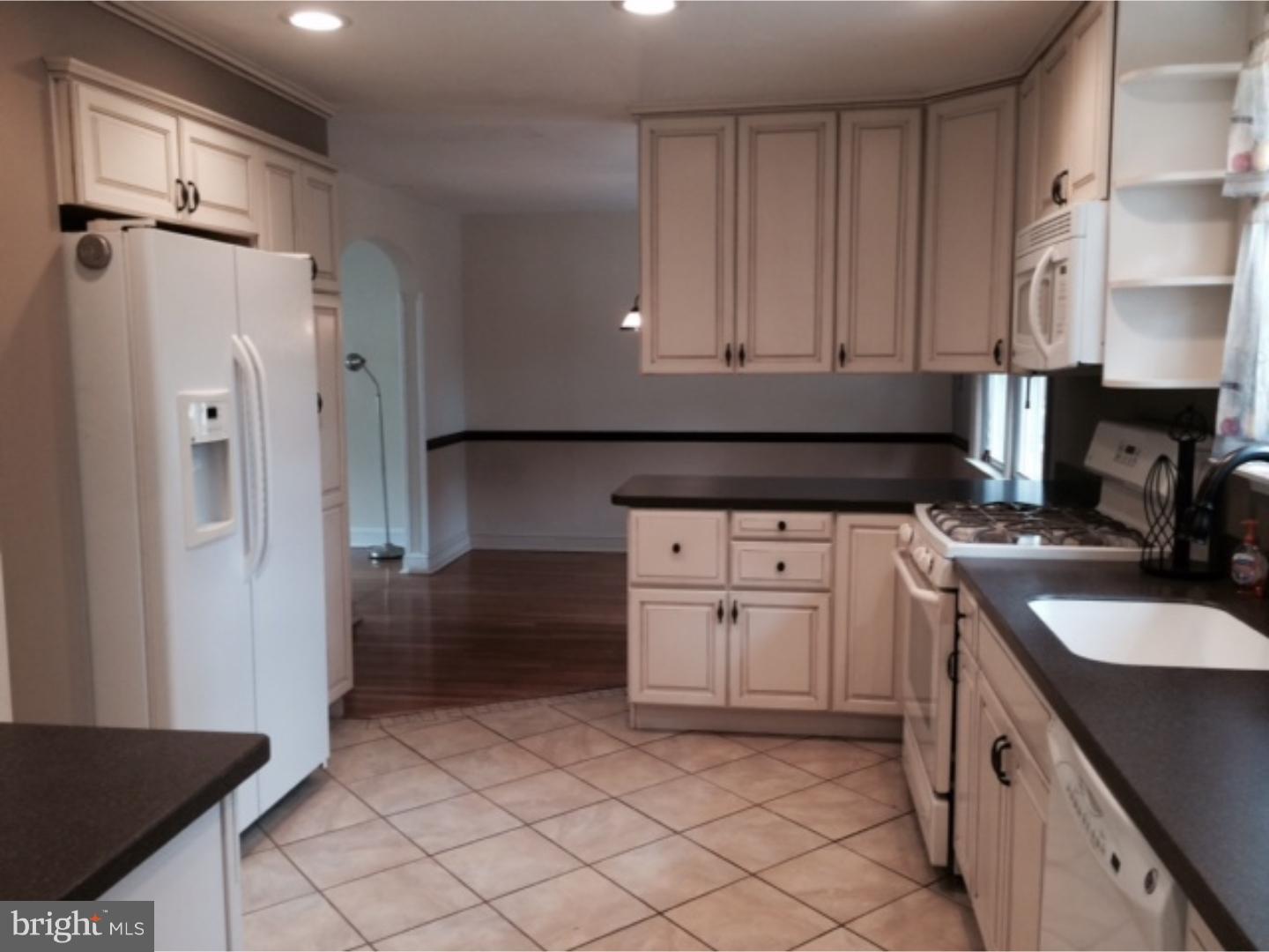737 Hilltop Road Springfield, PA 19064 - Photo 9 of 24 a kitchen with a refrigerator sink and cabinets