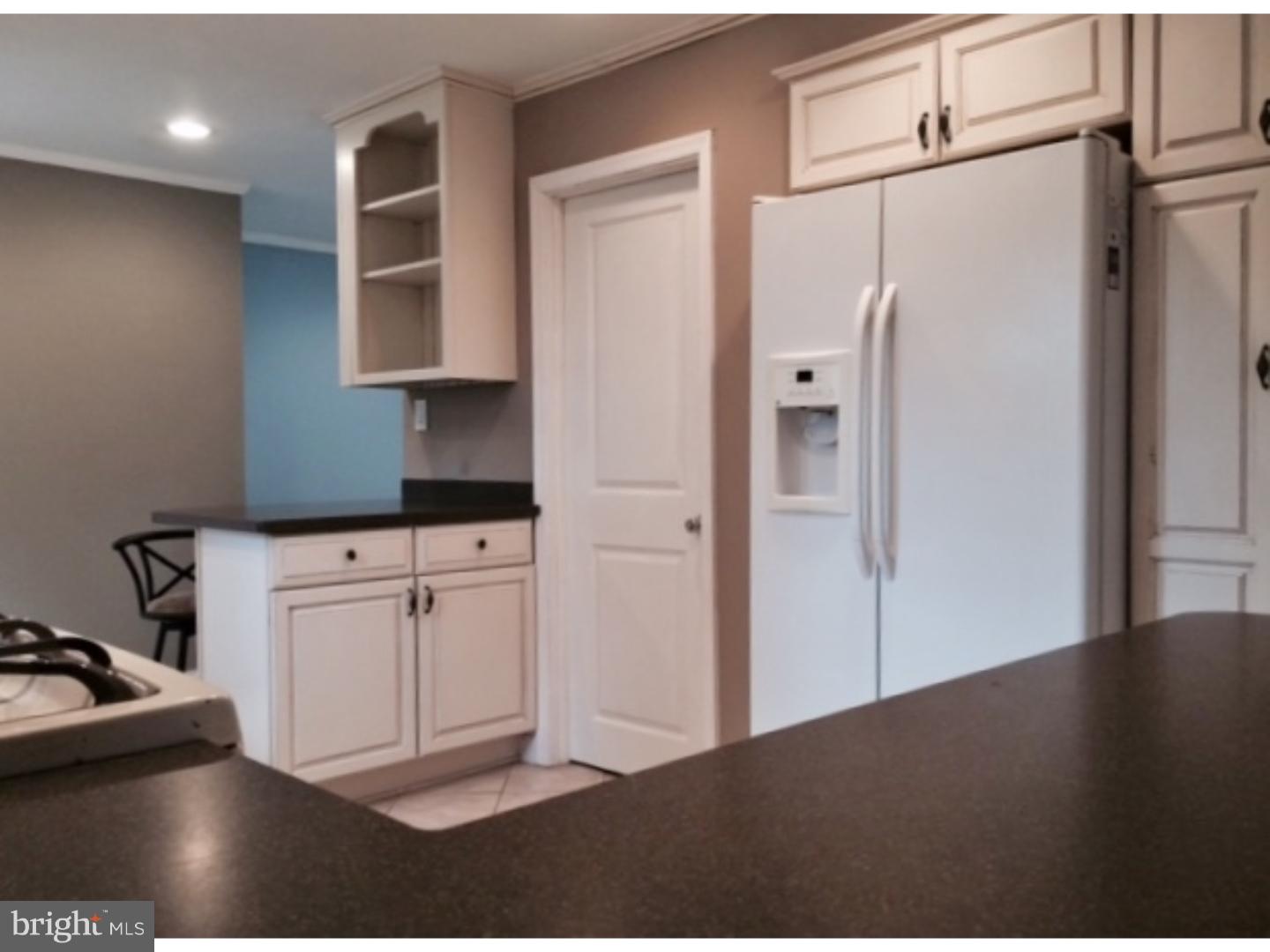 737 Hilltop Road Springfield, PA 19064 - Photo 10 of 24 a kitchen with white cabinets and refrigerator