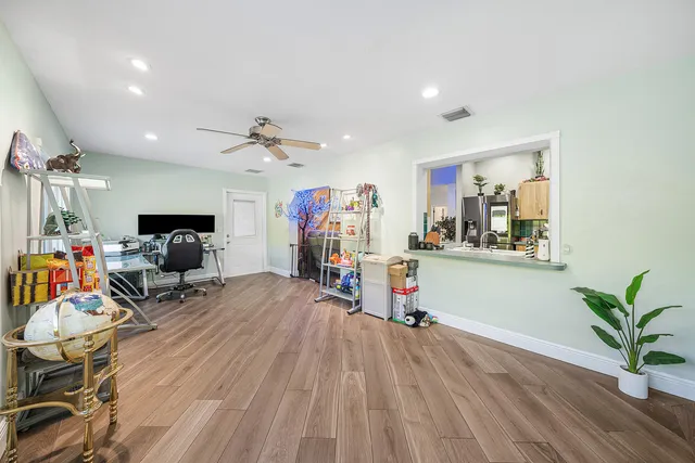 a view of a livingroom with furniture and a ceiling fan