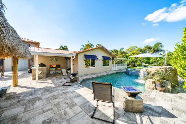 a backyard of a house with table and chairs