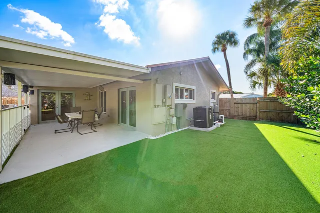 a view of a house with a backyard porch and sitting area