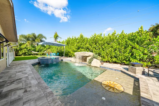 a view of a backyard with plants and a patio