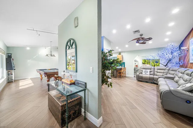 a living room with furniture and a chandelier
