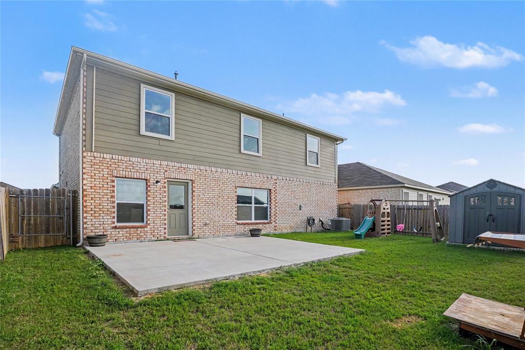 125 Sammy Venus, TX 76084 - Photo 31 of 39 Rear exterior featuring brick and siding facade, private concrete patio, and fenced yard
