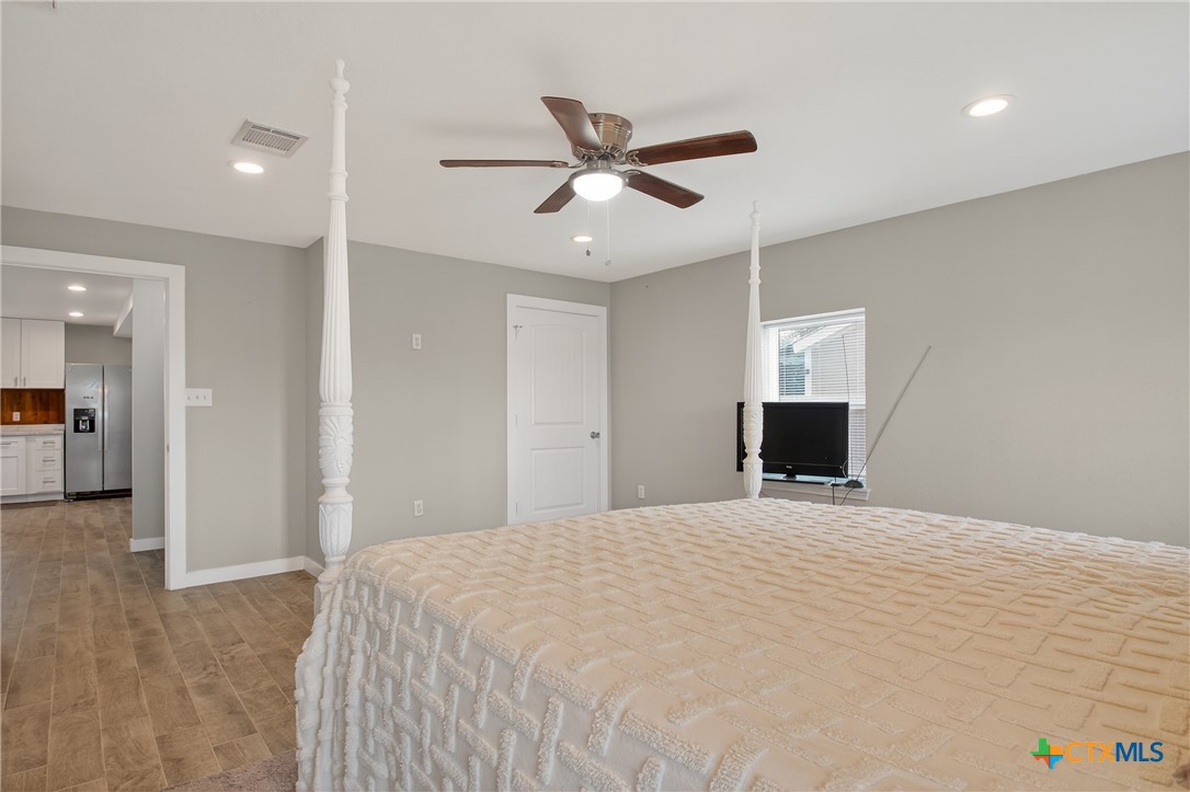 617 Bartlett Road Victoria, TX 77905 - Photo 22 of 30 a bedroom with a bed and a ceiling fan
