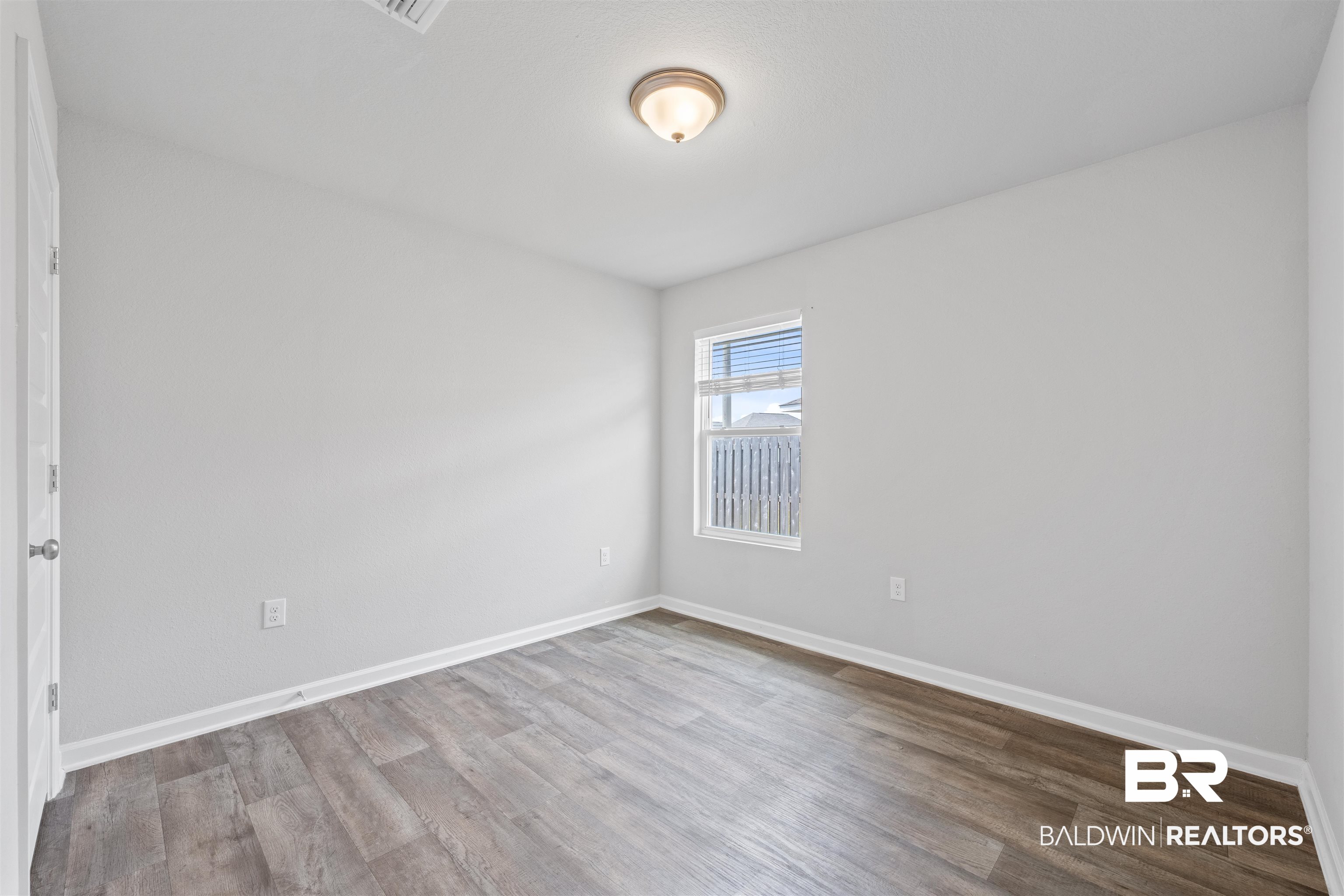 7457 Brompton Drive Foley, AL 36535 - Photo 19 of 24 Unfurnished room featuring light wood-style floors and baseboards