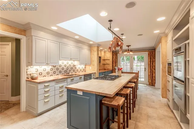 a kitchen that has a stove and a table in it