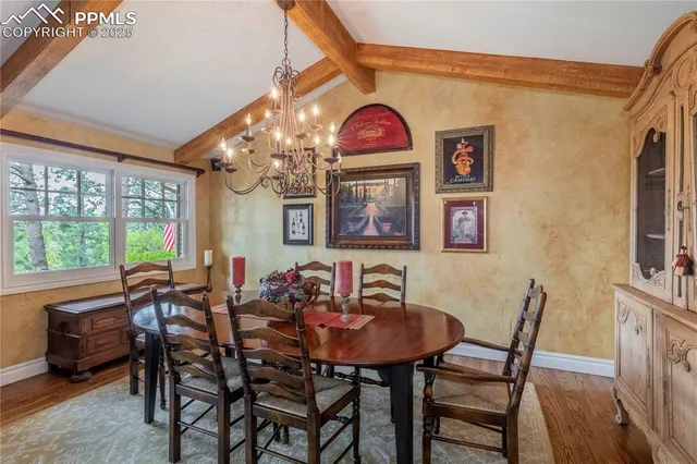 a living room with furniture a fireplace and a large window
