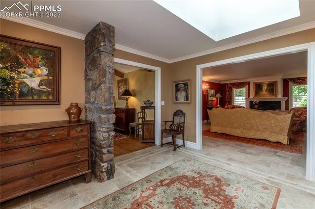 a bedroom with furniture and a large window