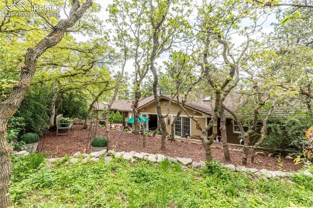 a view of a house with backyard and sitting area