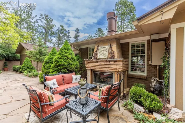 a backyard of a house with table and chairs