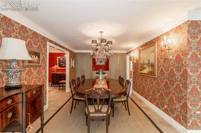 a view of a dining room with furniture and chandelier