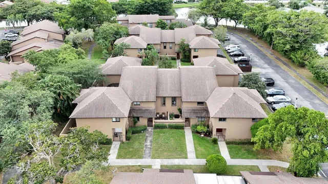 an aerial view of a house with garden space and street view