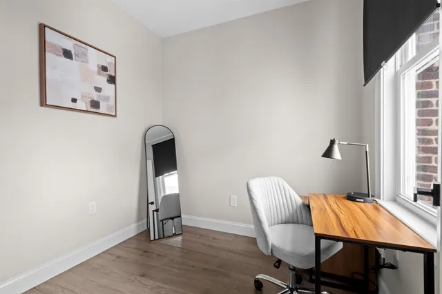 a workspace room with furniture and wooden floor