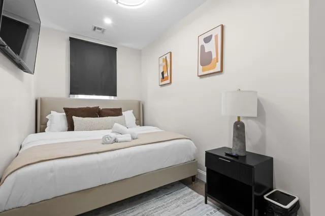 a bedroom with a bed and a flat screen tv