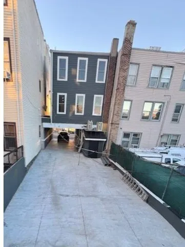 a view of backyard with a chair and floor to ceiling window