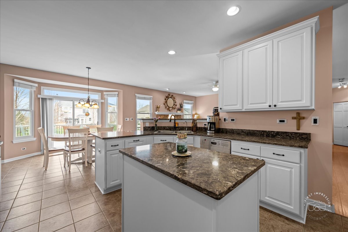 2519 Imgrund Road North Aurora, IL 60542 - Photo 11 of 33 a kitchen with stainless steel appliances granite countertop a stove a sink a microwave and dining table