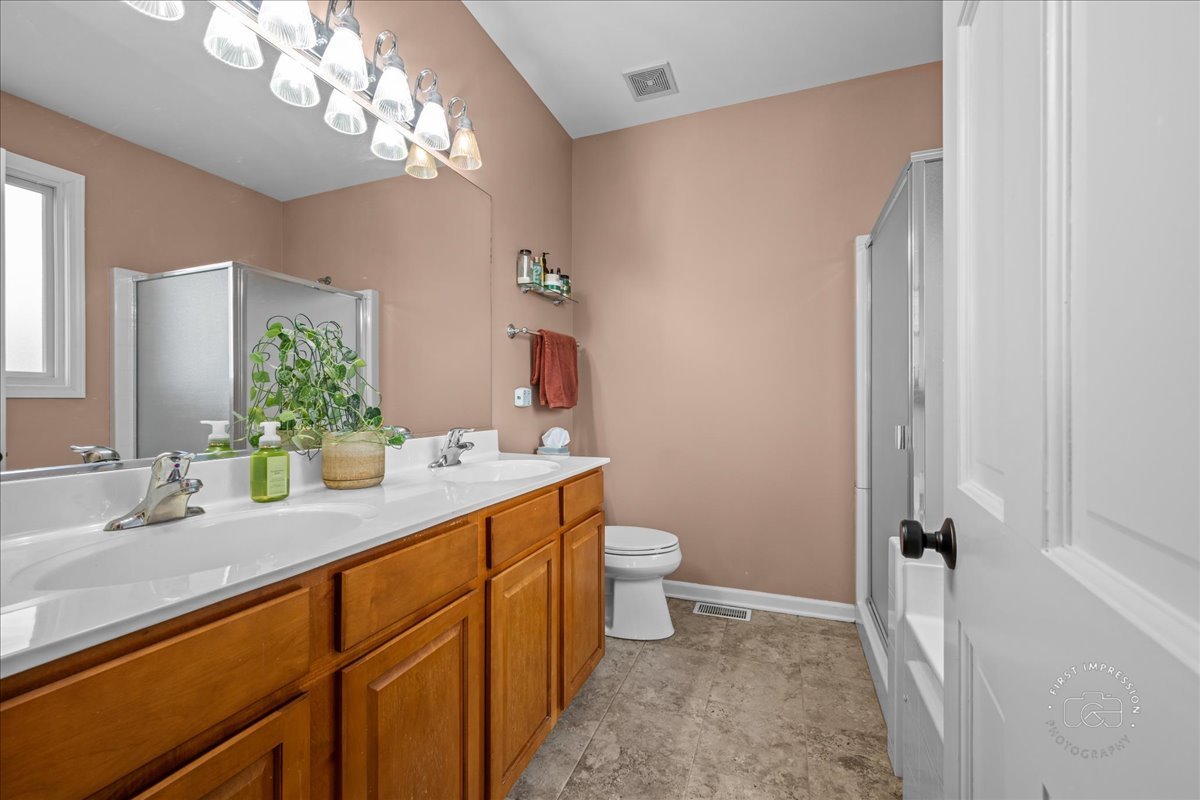 2519 Imgrund Road North Aurora, IL 60542 - Photo 17 of 33 a bathroom with a sink a toilet and a mirror