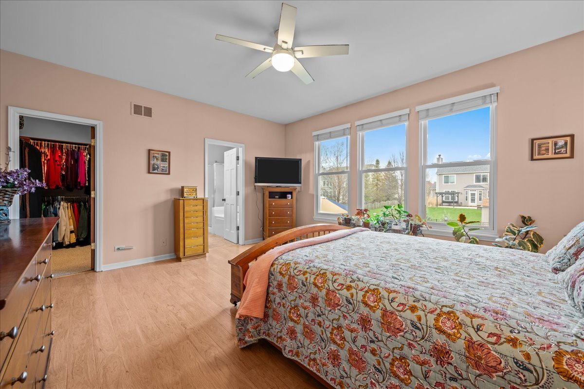 2519 Imgrund Road North Aurora, IL 60542 - Photo 20 of 33 a bedroom with a bed and a flat tv screen on dresser