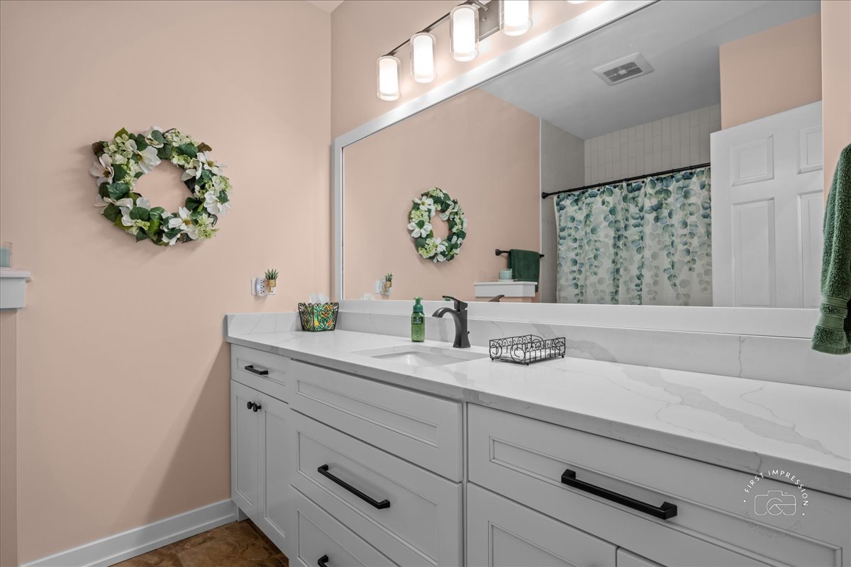 2519 Imgrund Road North Aurora, IL 60542 - Photo 22 of 33 a bathroom with a sink a vanity and a window