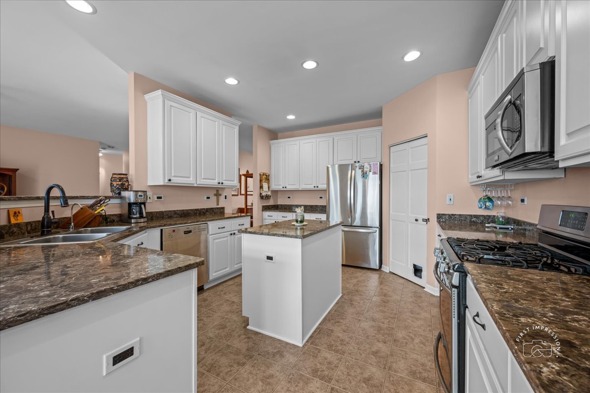2519 Imgrund Road North Aurora, IL 60542 - Photo 9 of 33 a kitchen with stainless steel appliances granite countertop a sink stove and refrigerator