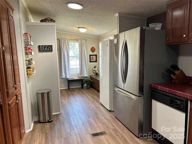 a kitchen with stainless steel appliances a refrigerator and a stove