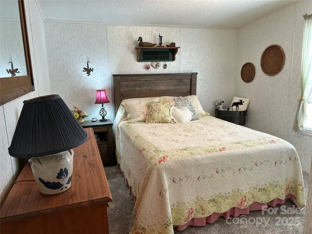 a bedroom with a bed and a fireplace