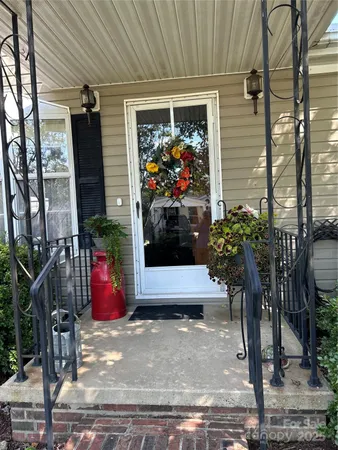 a potted plant sitting in front of a house