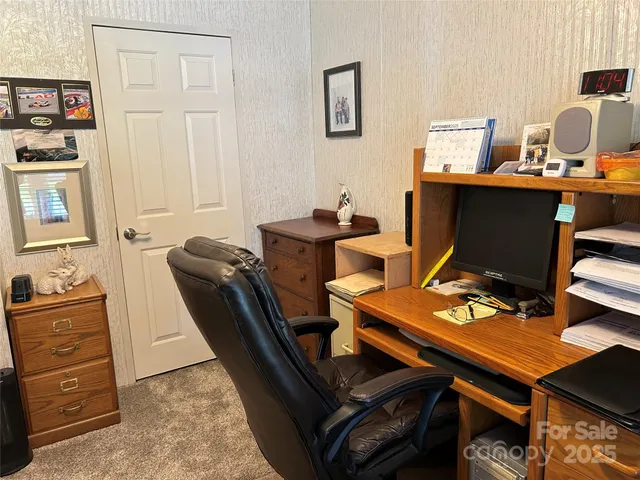 a view of a workspace with furniture and lamp