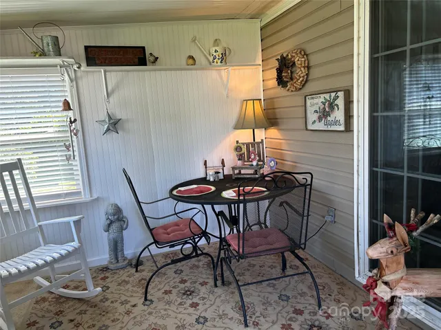 a view of a room that has a table and chair