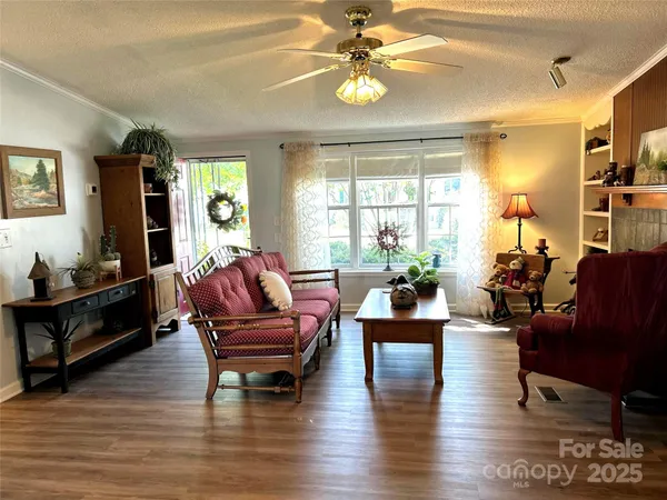 a living room with fireplace furniture and a wooden floor