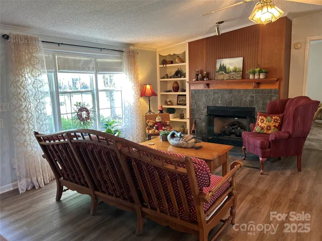 a living room with furniture a fireplace and a table