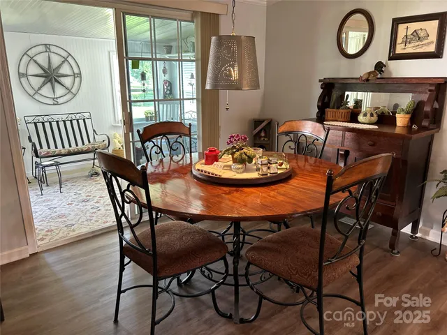 a dining room with furniture wooden floor and a rug