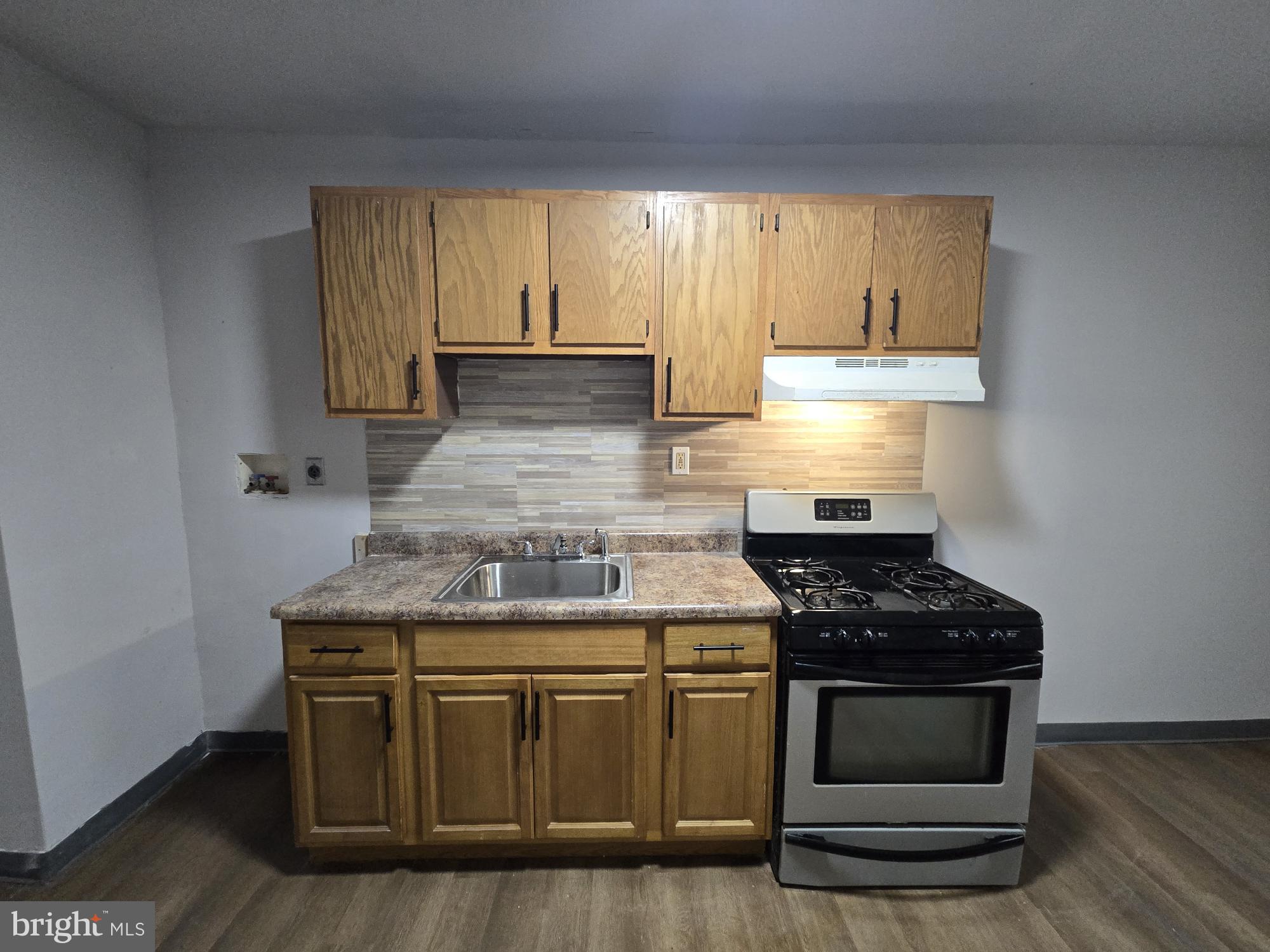 6138 North Lambert Street Philadelphia, PA 19138 - Photo 11 of 25 a kitchen with stainless steel appliances granite countertop a stove and a white cabinets