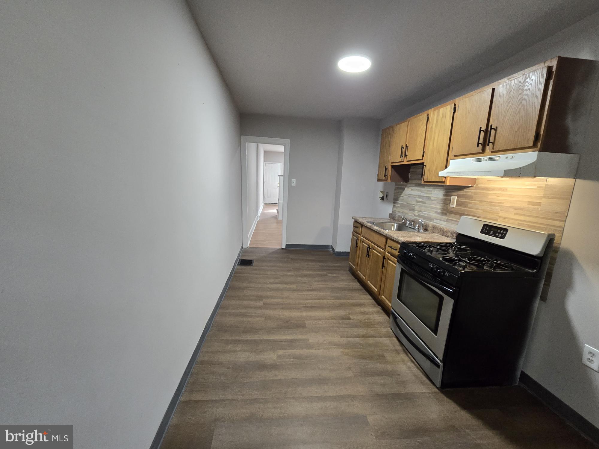 6138 North Lambert Street Philadelphia, PA 19138 - Photo 12 of 25 a kitchen with stainless steel appliances granite countertop a stove and a sink