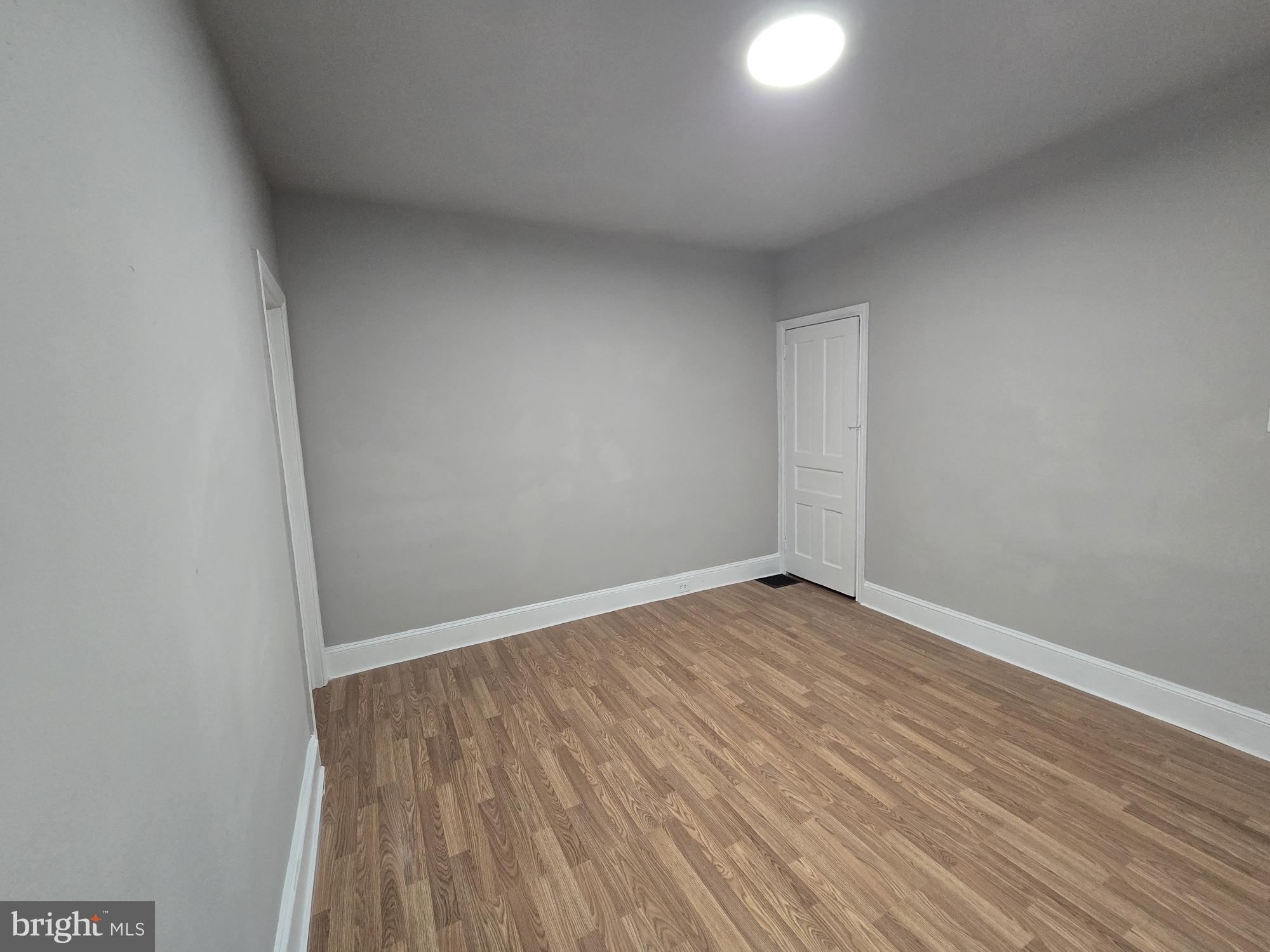 6138 North Lambert Street Philadelphia, PA 19138 - Photo 24 of 25 an empty room with wooden floor and windows