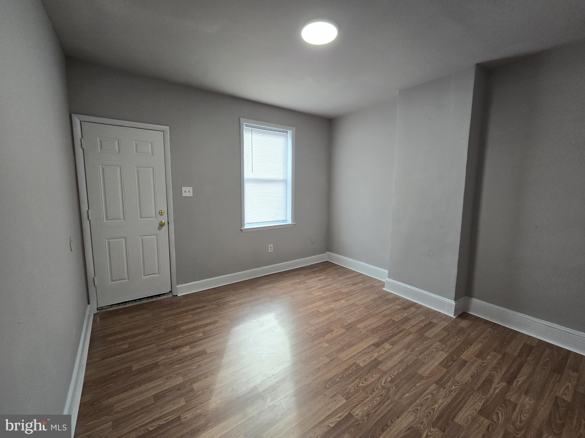 6138 North Lambert Street Philadelphia, PA 19138 - Photo 4 of 25 an empty room with wooden floor and windows