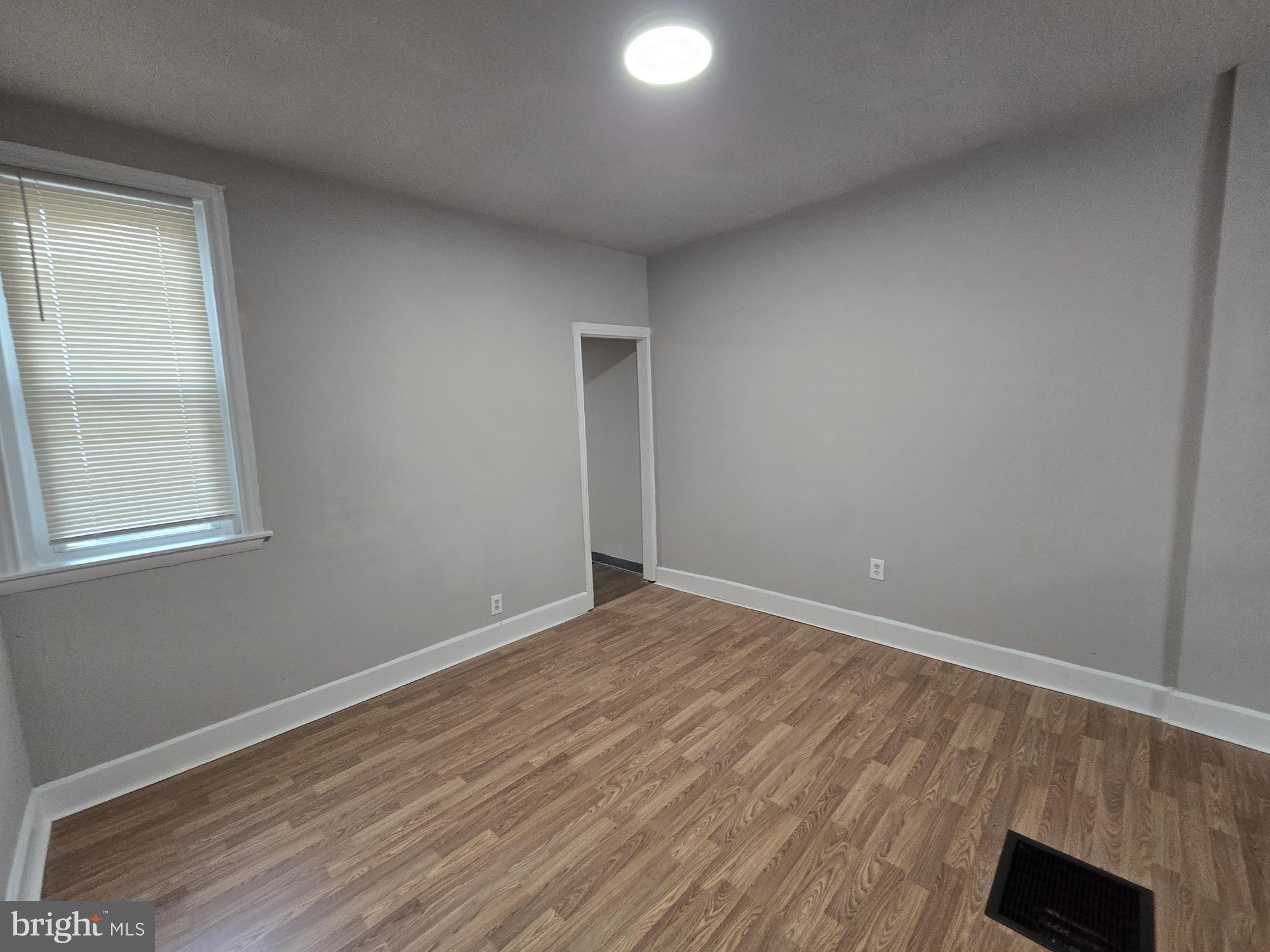 6138 North Lambert Street Philadelphia, PA 19138 - Photo 8 of 25 an empty room with wooden floor and windows
