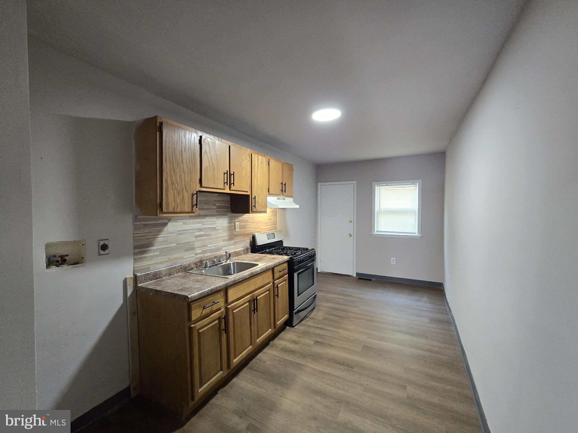 6138 North Lambert Street Philadelphia, PA 19138 - Photo 9 of 25 a kitchen with stainless steel appliances granite countertop a stove a sink and a refrigerator