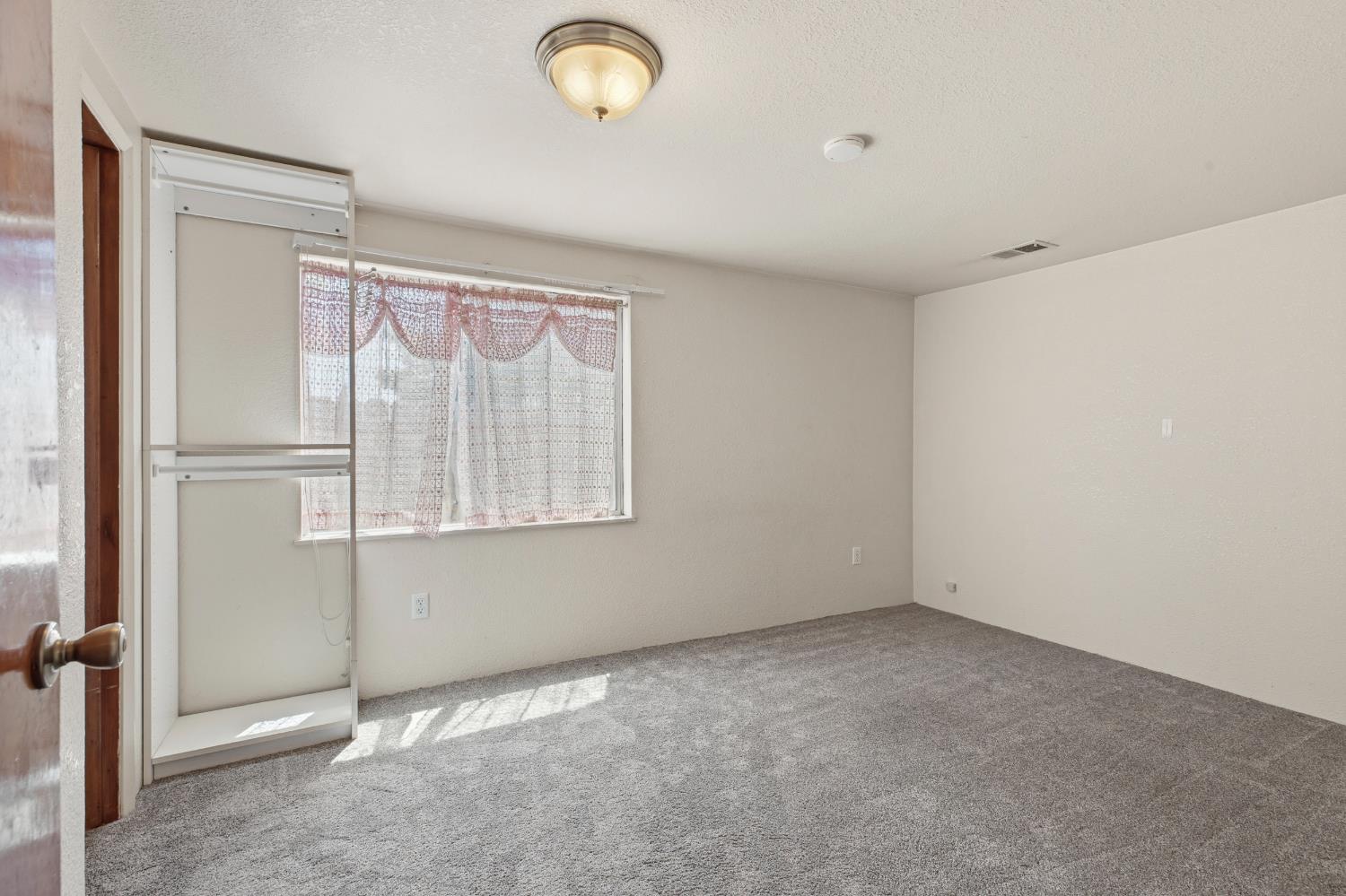 638 Orange Avenue Ripon, CA 95366 - Photo 12 of 30 a view of an empty room with a window