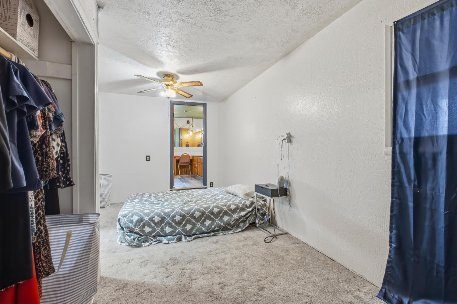 638 Orange Avenue Ripon, CA 95366 - Photo 17 of 30 a bedroom with a bed and a chandelier