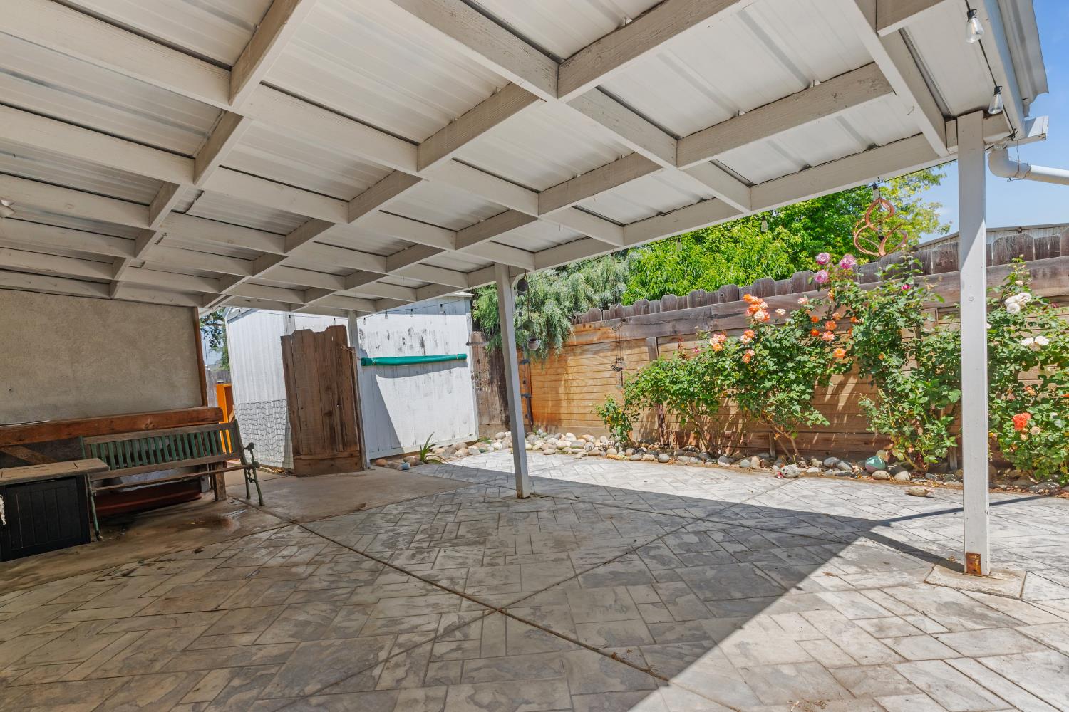 638 Orange Avenue Ripon, CA 95366 - Photo 23 of 30 a view of a patio with a table and chairs next to a yard