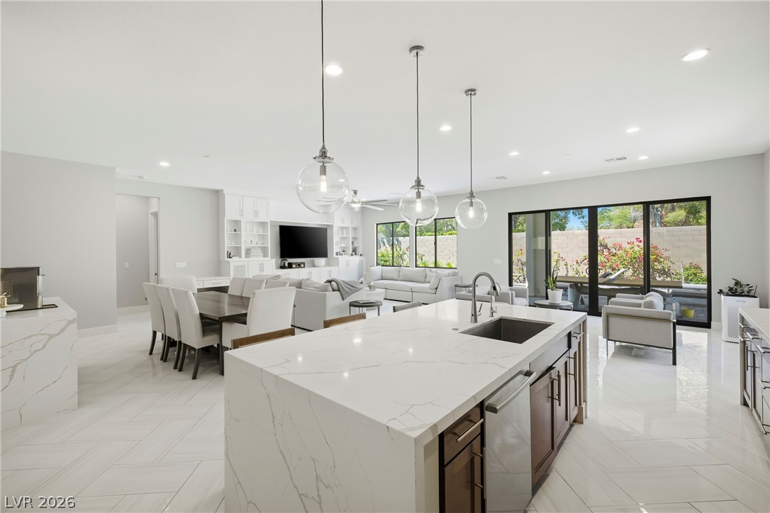 45 Garibaldi Way Henderson, NV 89011 - Photo 11 of 74 A luminous open-concept layout presents a modern kitchen island with pendant lighting and views to the verdant private yard.