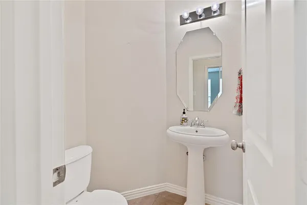 a bathroom with a sink mirror and toilet