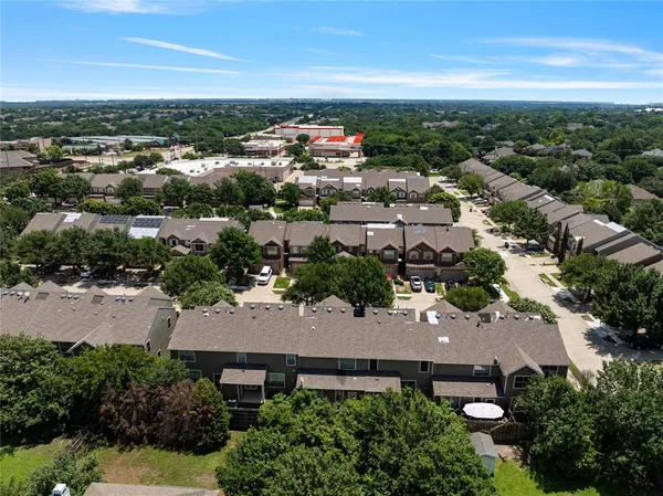 an aerial view of residential houses with outdoor space
