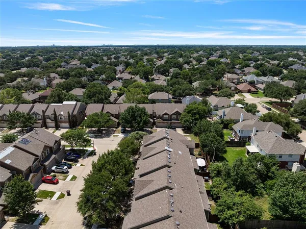 an aerial view of residential houses with outdoor space